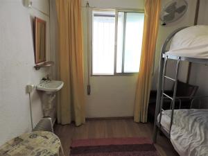 a small room with a bunk bed and a sink at El Cascabel in Granada