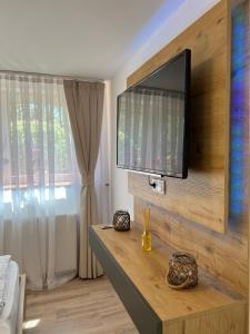 a living room with a flat screen tv on a wall at Ferienwohnung Bispingen in Bispingen