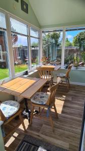 a dining room with a wooden table and chairs at Morland in Burrowbridge