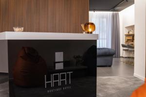 a living room with a table with a rift sign at Hart Boutique Hotel in Naples