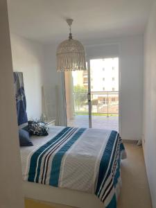 a bedroom with a bed and a large window at Oliveres in Hospitalet de l'Infant