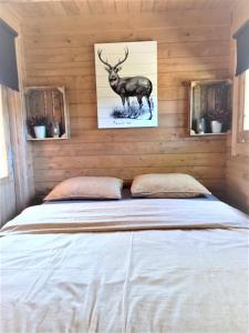 a bed in a room with a picture of a deer at 't Hertje in Ermelo