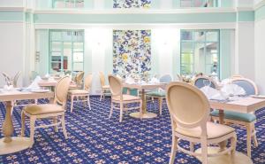 a dining room with tables and chairs at AX The Victoria Hotel in Sliema
