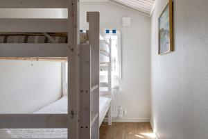 a room with two bunk beds and a hallway at Holiday house with terrace and views of Lake Hangasjon in Hamneda