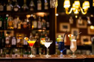 a group of four cocktails sitting on a bar at AX The Victoria Hotel in Sliema