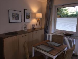 a small kitchen with a table and a window at Heimathafen Bad Bevensen in Bad Bevensen