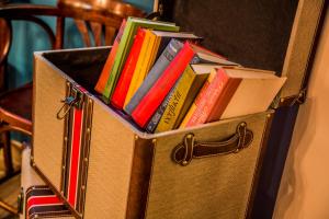 a box full of books sitting on a table at AX The Victoria Hotel in Sliema