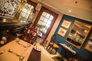 a room with a bar with a table and chairs at AX The Victoria Hotel in Sliema