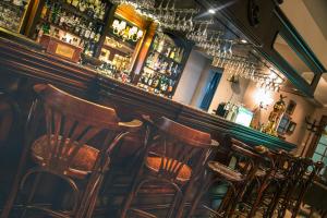 a bar with a row of wooden chairs in a room at AX The Victoria Hotel in Sliema