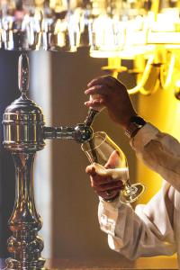 a person is pouring a glass of wine at AX The Victoria Hotel in Sliema