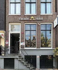 a facade of a brick building with a hotel at Facade Hotel Amsterdam in Amsterdam