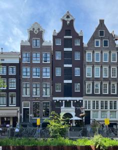 a row of tall buildings in a city at Facade Hotel Amsterdam in Amsterdam
