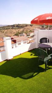 a patio with two chairs and an umbrella at CASA LATY in La Fregeneda