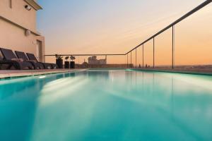 a swimming pool on the roof of a building at AX The Victoria Hotel in Sliema