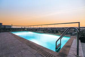 a swimming pool on the roof of a building at AX The Victoria Hotel in Sliema