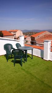 a table and chairs on a roof with green grass at CASA LATY in La Fregeneda