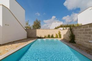 a swimming pool in the backyard of a house at Quintino Apartments Pool in Torre Lapillo