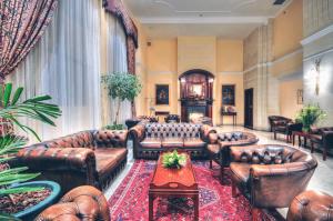 a living room with leather couches and a table at AX The Victoria Hotel in Sliema