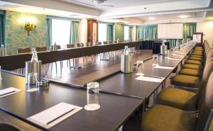 a conference room with long tables and chairs in it at AX The Victoria Hotel in Sliema