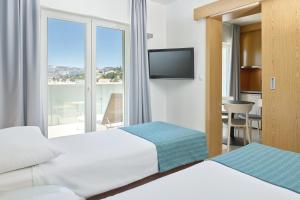 Ein Bett oder Betten in einem Zimmer der Unterkunft Maistra Select Mlini Villas and Apartments