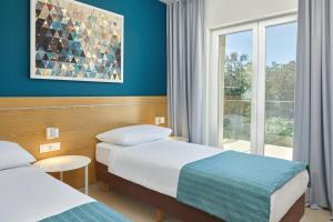 Ein Bett oder Betten in einem Zimmer der Unterkunft Maistra Select Mlini Villas and Apartments