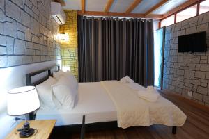 A bed or beds in a room at Oceanic Overview Suites