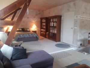 a bedroom with a bed and a book shelf at le Trésor de Gabaret in Burosse-Mendousse