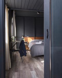 a bedroom with a bed and a table and a desk at Luma Boutique Hotel in San Carlos de Bariloche