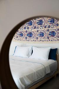 a bedroom with a bed with a large mirror at Spa Eilat Mountain Lodge in Eilat