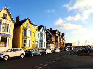 a group of cars parked on the side of a street at Ayrton House Holiday Apartments in Blackpool