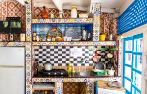 a kitchen with colorful tiles on the wall at White And Blue in Essaouira