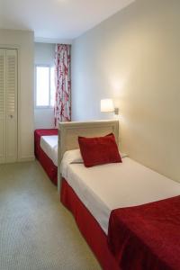 a hotel room with two beds and a window at Ona Marinas de Nerja Spa Resort in Nerja