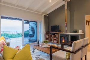 a living room with a couch and a fireplace at Grootbos Private Nature Reserve in Gansbaai