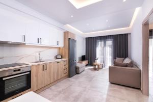 a kitchen and living room with a couch and a table at Lithies Zante Living in Zakynthos Town