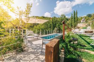 a backyard with a swimming pool and an umbrella at Villa la Rocca in Ceretana
