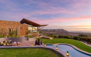 a backyard with a pool and a house at Grootbos Private Nature Reserve in Gansbaai