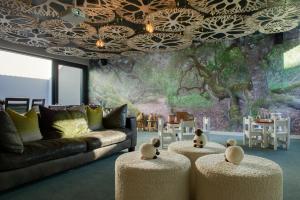 a living room with two teddy bears sitting on stools at Grootbos Private Nature Reserve in Gansbaai