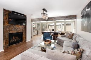 a living room with a couch and a fireplace at Villa's of Aspen by Snowmass Vacations in Aspen