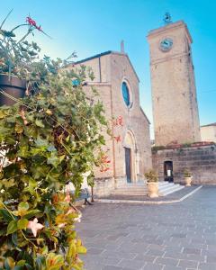 a church with a clock tower in front of it at Casetta Rocca in Rocca San Giovanni