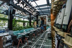 a restaurant with tables and chairs in a building at The Crown Boutique Hotel & SPA in Tirana