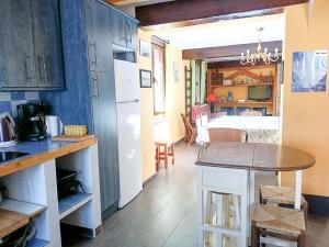 a kitchen with a table and a dining room at Casa rural La Antigua Herrería in Arandilla del Arroyo