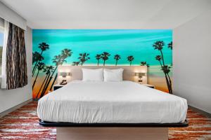 a bedroom with a large bed and a large window at Avania Inn of Santa Barbara in Santa Barbara
