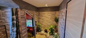 a hallway with a video game in a brick wall at Rêves de vie, suite vue mer, grande piscine privée , spa privatif in Cassis