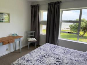 a bedroom with a bed and a window at Sunset Paradise in Cape Town