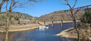 a boat in a river under a bridge at Garabit Hotel in Garabit