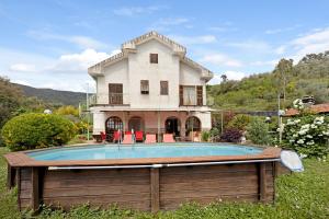 a house with a swimming pool in front of a house at Villa La Casa di Giacomo in Pigna