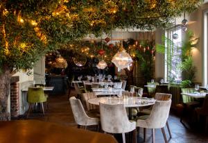 a restaurant with tables and chairs and lights at J.D.Young in Harleston