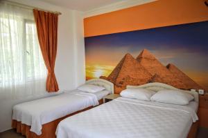 A bed or beds in a room at Elit Deniz Palamutbükü