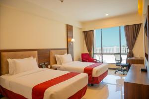 Postel nebo postele na pokoji v ubytování Hotel Tip Top International Pune