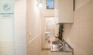 a small bathroom with a sink and a toilet at Casa Camerini by MONHOLIDAY in Villanova di Ostuni